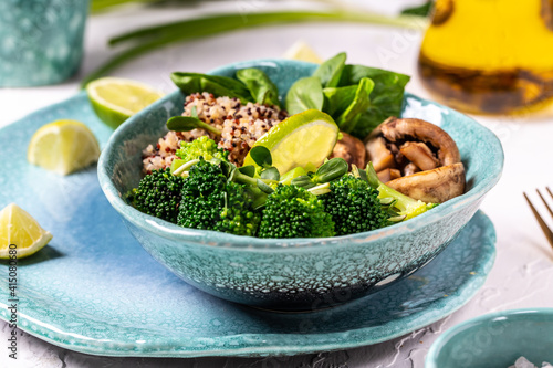 Green vegetable vegan salad with spinach, mushrooms and broccoli and quinoa. Healthy vegetarian food concept. top view