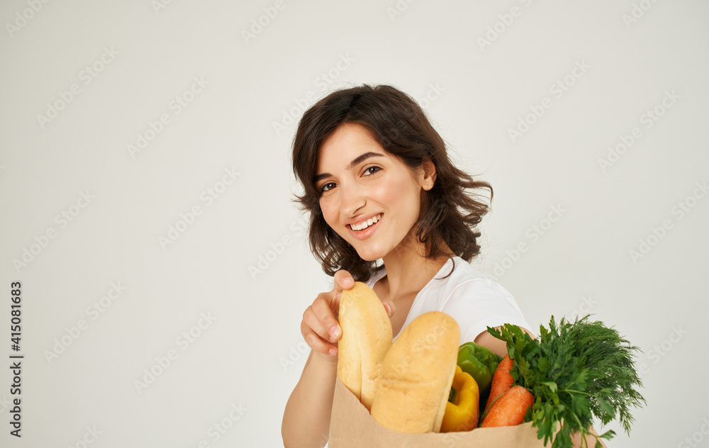 Brunette in a white T-shirt eating healthy food Brunette in a white T-shirt eating healthy food