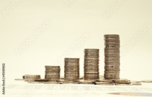 Graph from coins,Business growth concept,Financial growth,Increasing piles of coins on white background