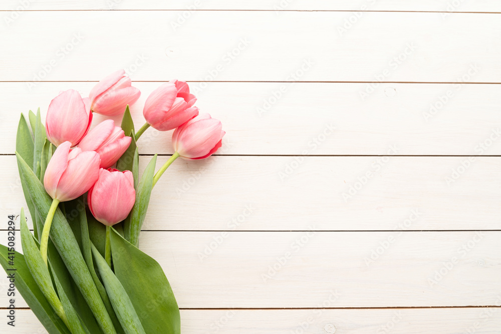 pink tulips over white wooden table background with copy space pink tulips over white wooden table background with copy space