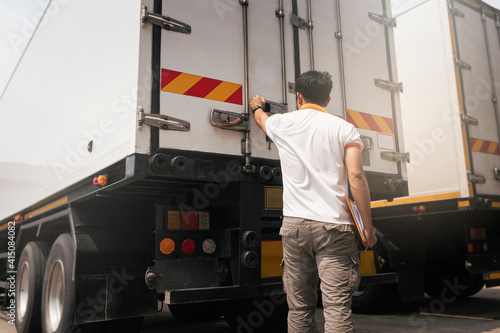 Truck driver checking container door security. Truck inspection safety and maintenance.