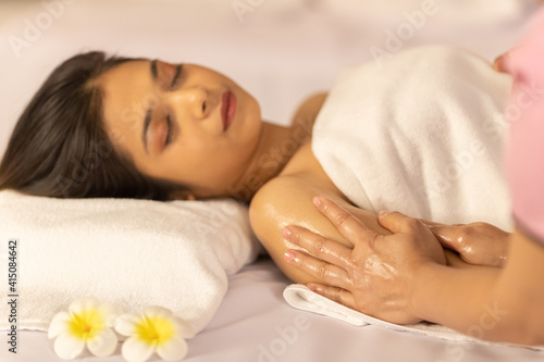 Asian woman sleep in spa and the massager tender massage her head. Idea for relax and aroma therapy.