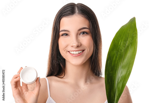 Smiling young woman holding...