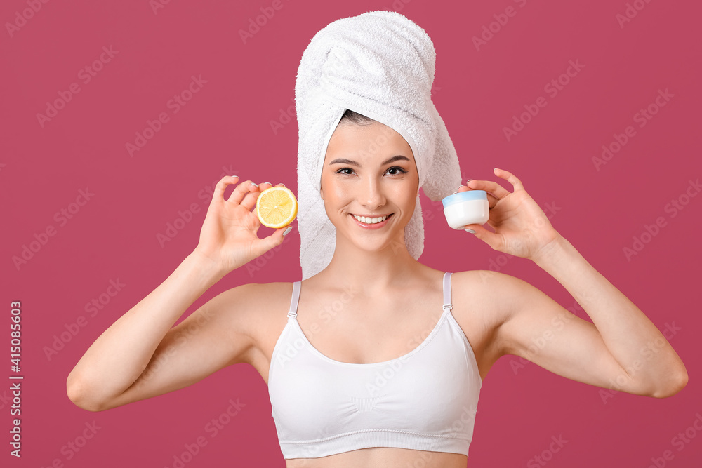 Beautiful young woman with facial cream and lemon on color background Beautiful young woman with facial cream and lemon on color background