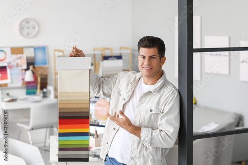 Male interior designer with color samples in his office