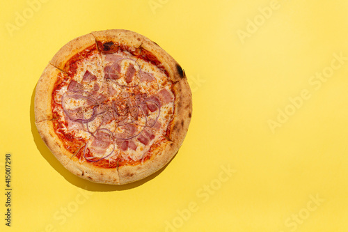 one ready-made pizza on a yellow background