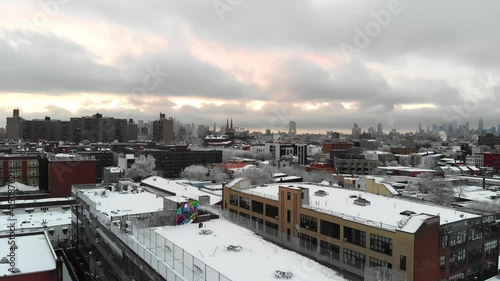 Combing the rooftops of Brooklyn, NY's East Williamsburg, this aerial shot explores the skies right after a large snow storm. photo