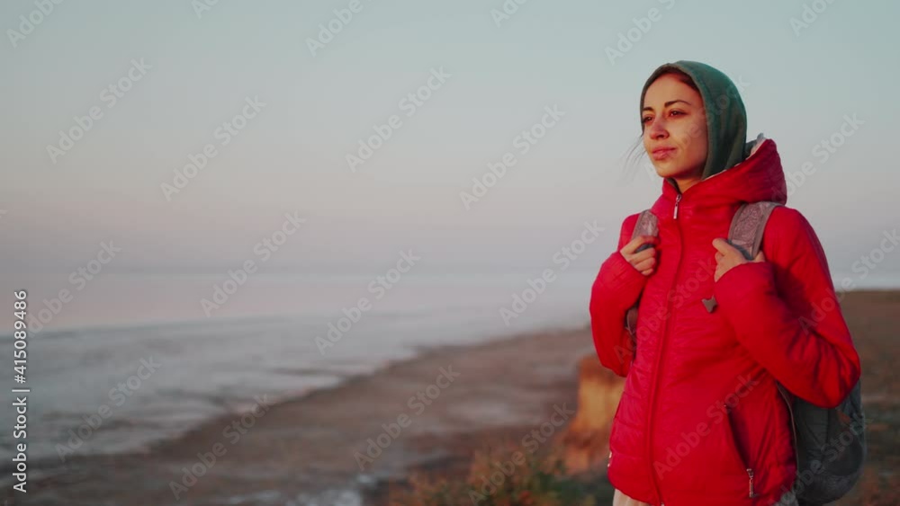 young woman traveler with backpack meeting sunrise at deserted sea beach, sightseeing and looking around, enjoying freedom, fresh air and nature beauty young woman traveler with backpack meeting sunrise at deserted sea beach, sightseeing and looking around, enjoying freedom, fresh air and nature beauty