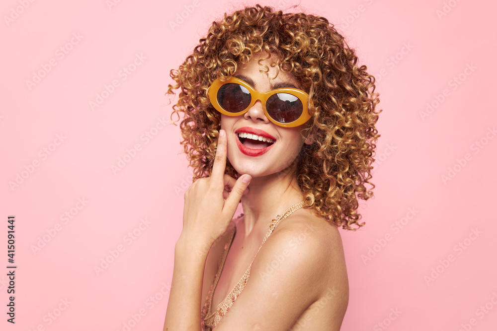 Lady Curly hair smile red lips trendy glasses pink background bright makeup 