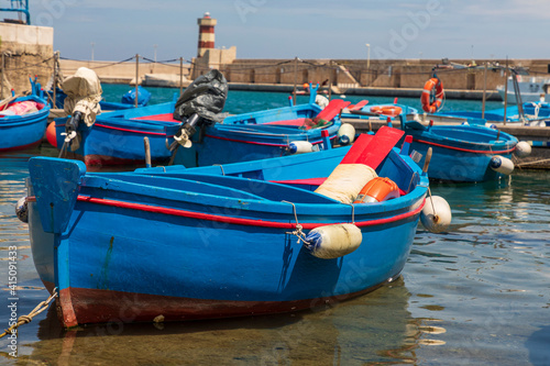 Italy, Apulia, Metropolitan City of Bari, Monopoli. Porto di Monopoli. Blue and red fishing boats in the harbor.