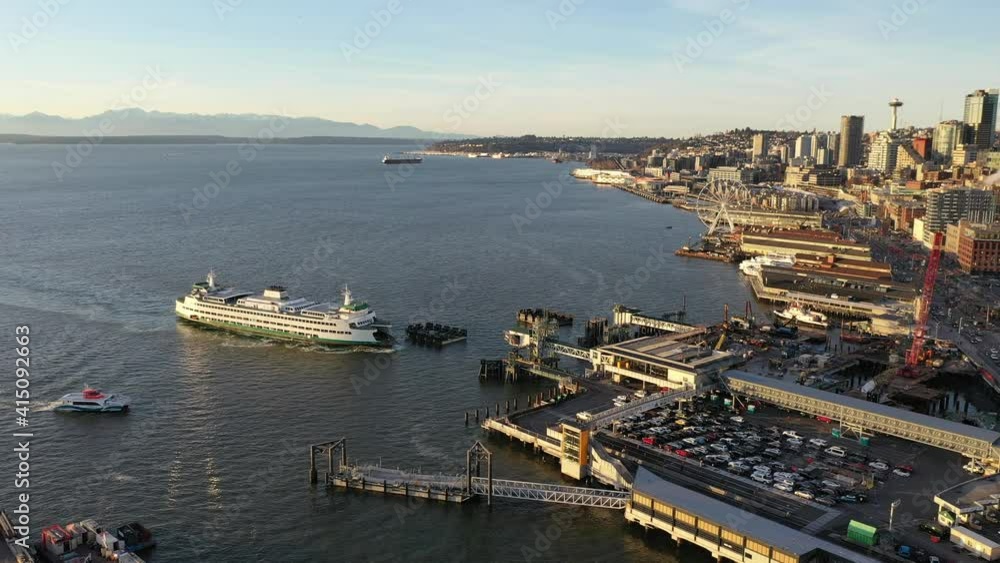 Drone dolly shot of the Seattle Bainbridge Ferry, Great Wheel, Seattle Aquarium, Cruise Terminal, Seattle downtown, waterfront, piers, empty Alaskan Way with skyscrapers, during the pandemic Drone dolly shot of the Seattle Bainbridge Ferry, Great Wheel, Seattle Aquarium, Cruise Terminal, Seattle downtown, waterfront, piers, empty Alaskan Way with skyscrapers, during the pandemic