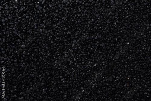 Japanese asphalt pavement with a beautiful black texture and lit with a soft light.