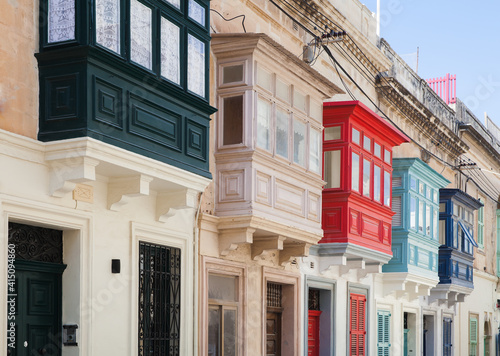Street view with colorful old balconies. Living houses of Malta