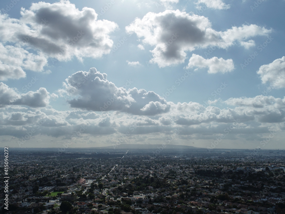 Aerial view of the LA basin with the sun streaking through the clouds