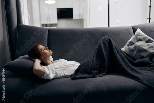 woman lies on sofa and soft pillow interior © SHOTPRIME STUDIO