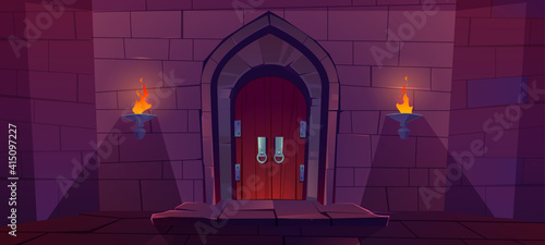 Wood door in medieval castle. Old gate in stone wall with flaming torches at night. Vector cartoon illustration of entrance to dungeon, prison or fortress. Wooden double doors with round knob knock