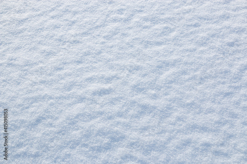 White snow winter texture. Seasonal fresh white color snow nature backdrop wallpaper.  Crisp shiny  frosty snow on sunny day outdoor.