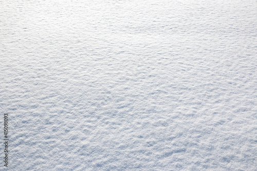 White snow winter texture. Seasonal fresh white color snow nature backdrop wallpaper. Crisp shiny frosty snow on sunny day outdoor.