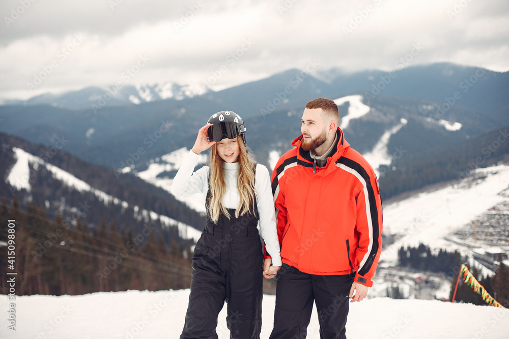 Couple in sport clothes. People spending winter vacation on mountains