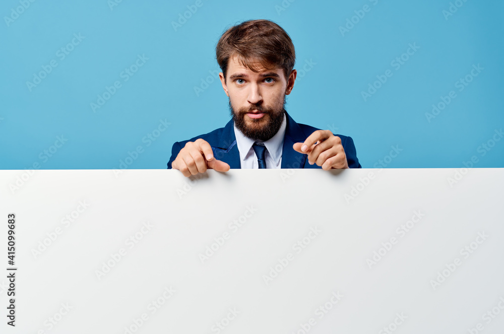 emotional business man peeking out from behind banner cropped view blue background Copy Space emotional business man peeking out from behind banner cropped view blue background Copy Space