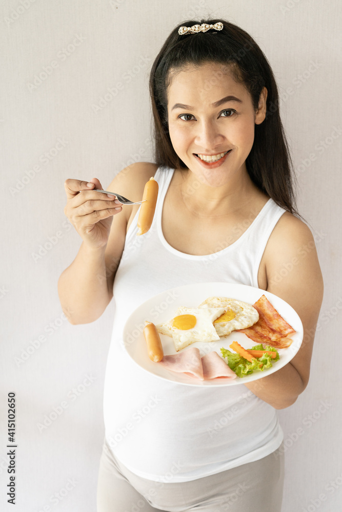Pregnant is happy and smiling to eat food for pregnant woman. Pregnant is happy and smiling to eat food for pregnant woman.