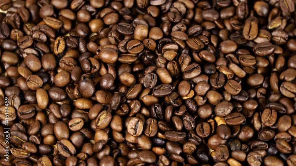 Rotating and falling. Coffee beans. Close up of seeds of coffee. Beautiful seeds of coffee. Fragrant coffee beans scrolls slowly around the camera. Rotating and falling. Coffee beans. Close up of seeds of coffee. Beautiful seeds of coffee. Fragrant coffee beans scrolls slowly around the camera.
