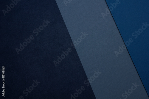 Dark background with black gray blue textured paper