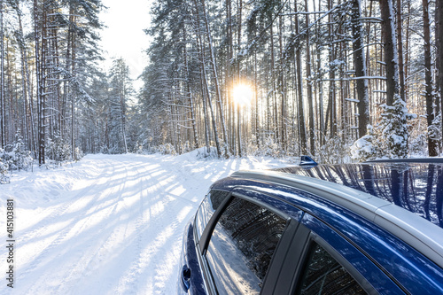 car on a winter road in a snowy forest, winter journey