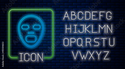 Glowing neon Facial cosmetic mask icon isolated on brick wall background. Cosmetology, medicine and health care. Neon light alphabet. Vector.