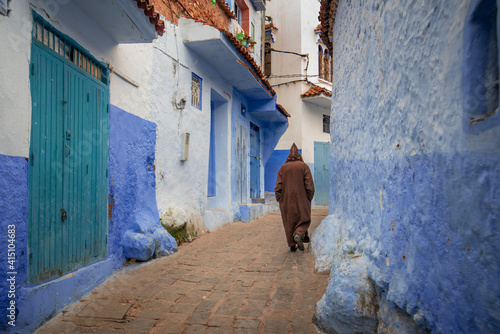 Walking man in CHEFCHAOUEN, MOROCCO. Beautiful view of the blue city in the medina. © mitzo_bs
