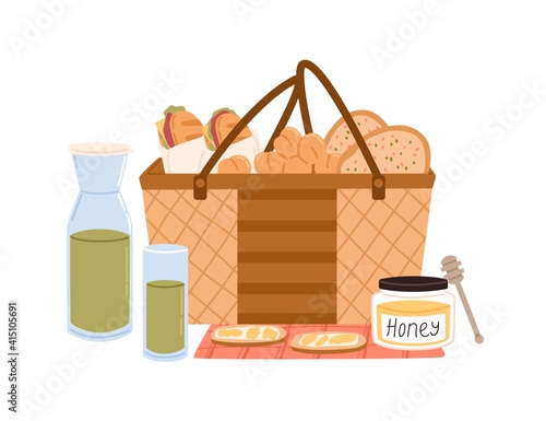 Composition of picnic basket with sandwiches and fruits, glass bottle of juic...