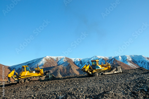 Bulldozer in process of working in an industrial mountain area