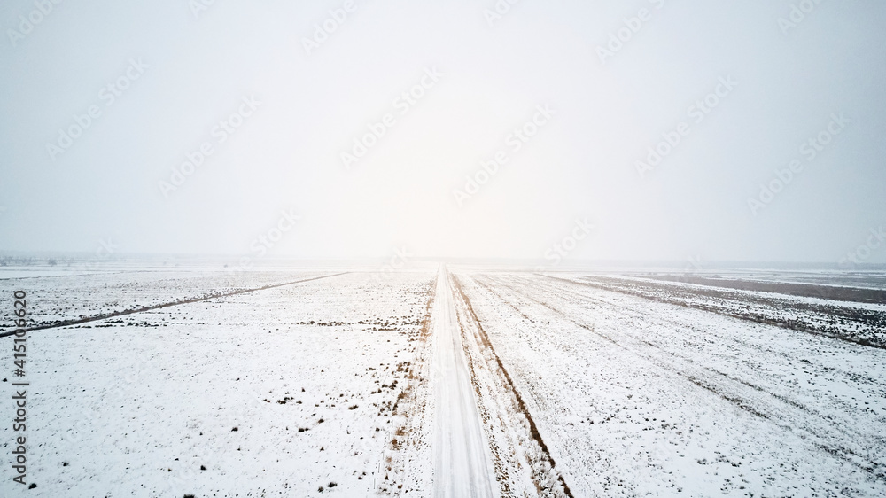 snow on a large empty road in winter