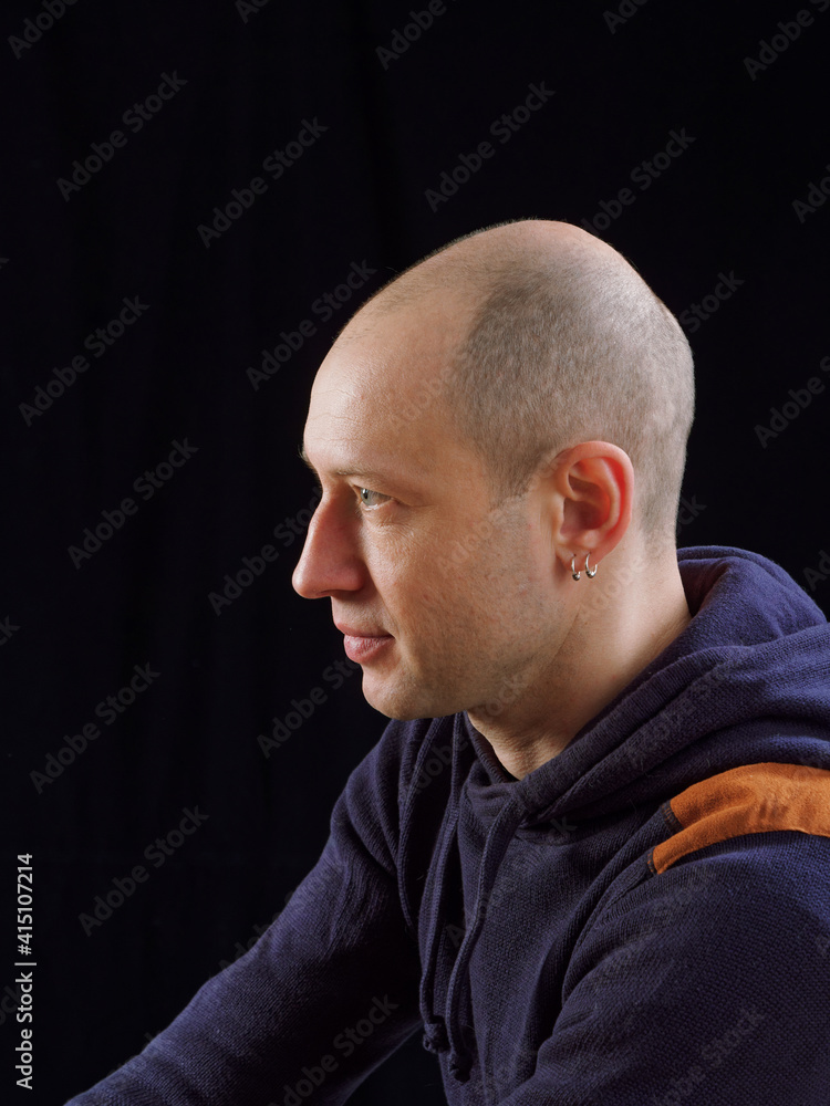 Fototapeta premium portrait of a bald man on a black background