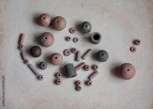 Handmade clay beads. Ceramic handcrafted items on a grunge background. Creative process. Top view.