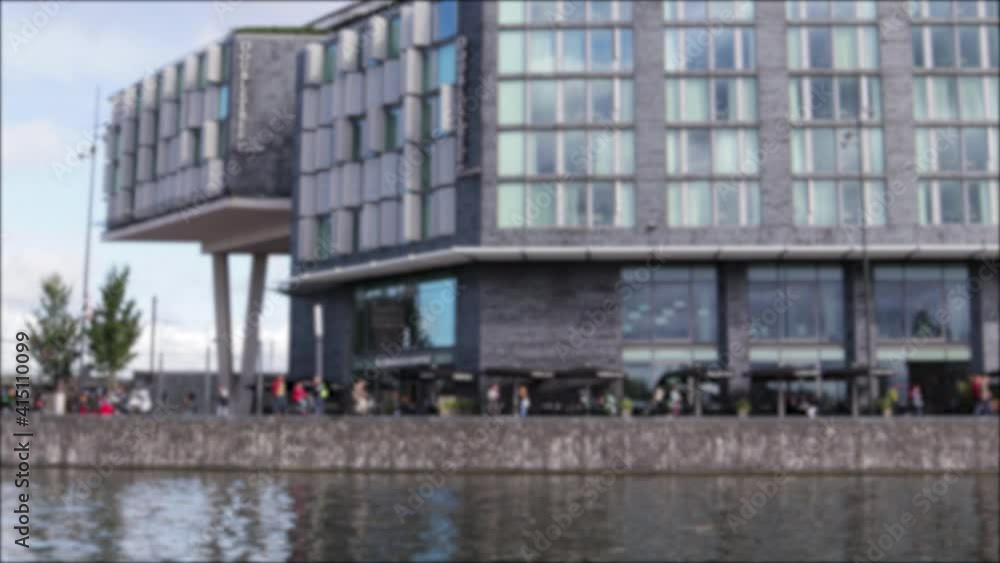 View from canal in city of buildings on the shore. View from canal in city of buildings on the shore.