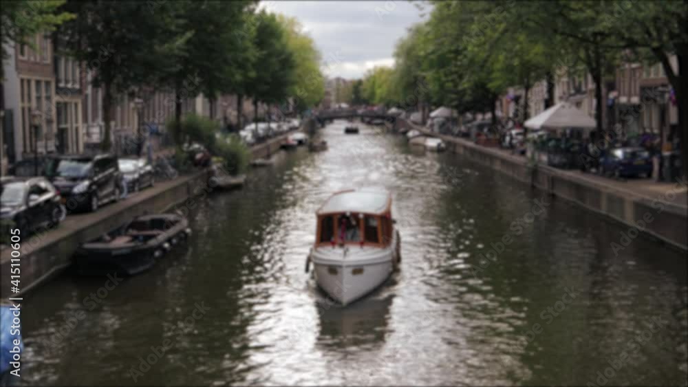 Boat on river in built up urban city Boat on river in built up urban city