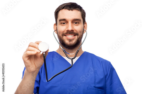 healthcare, profession and medicine concept - happy smiling doctor or male nurse in blue uniform with stethoscope over white background