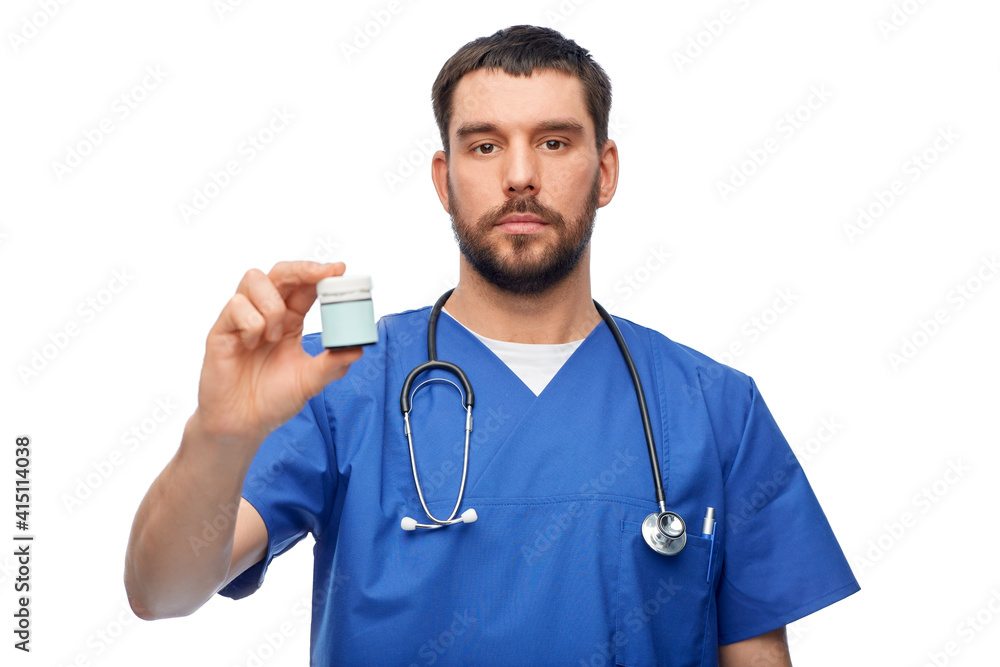 healthcare, profession and medicine concept - doctor or male nurse in blue uniform with jar of pills and stethoscope over white background healthcare, profession and medicine concept - doctor or male nurse in blue uniform with jar of pills and stethoscope over white background