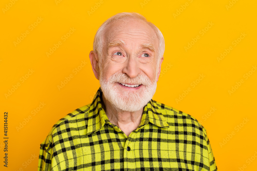 Photo of aged man happy positive smile dream dreamy look empty space grandfather isolated over yellow color background Photo of aged man happy positive smile dream dreamy look empty space grandfather isolated over yellow color background