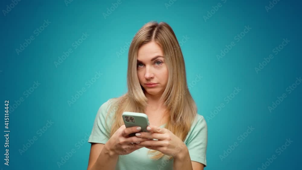 Young woman using her smartphone in studio Young woman using her smartphone in studio