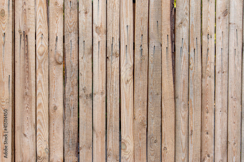 Wooden fence made of unedged boards