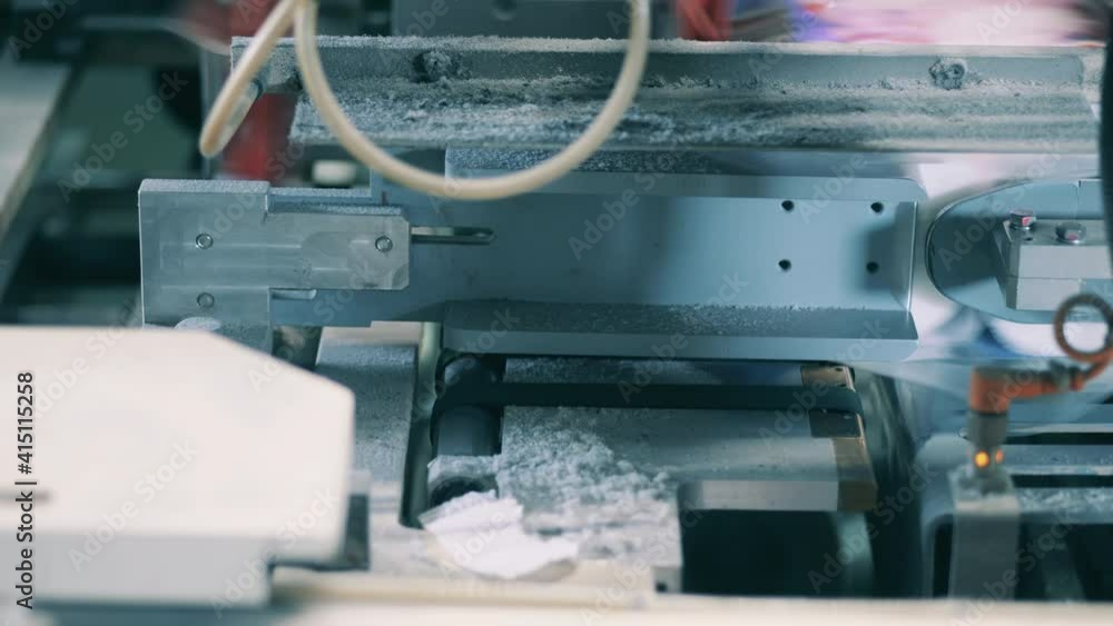 Close up shot of toilet paper rolls being packed by an automatic machine Close up shot of toilet paper rolls being packed by an automatic machine