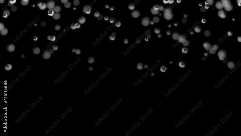 Water droplets are falling in slow motion on a dark background. Macro shot with shallow depth of field. Water droplets are falling in slow motion on a dark background. Macro shot with shallow depth of field.