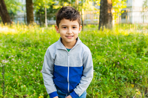 portrait of a 6 year old boy in the park in summer