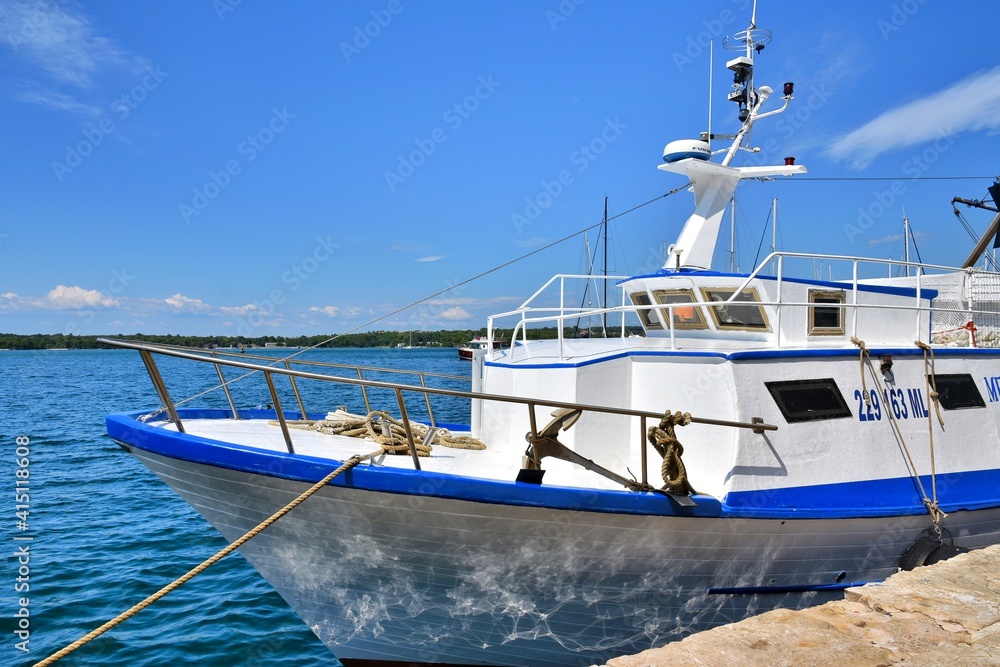 Pula, Croatia - August 2020: Fishing boats with tackle moored at the pier in the Pula, Croatia. Fishing ships in the port of Pula, Istria Pula, Croatia - August 2020: Fishing boats with tackle moored at the pier in the Pula, Croatia. Fishing ships in the port of Pula, Istria