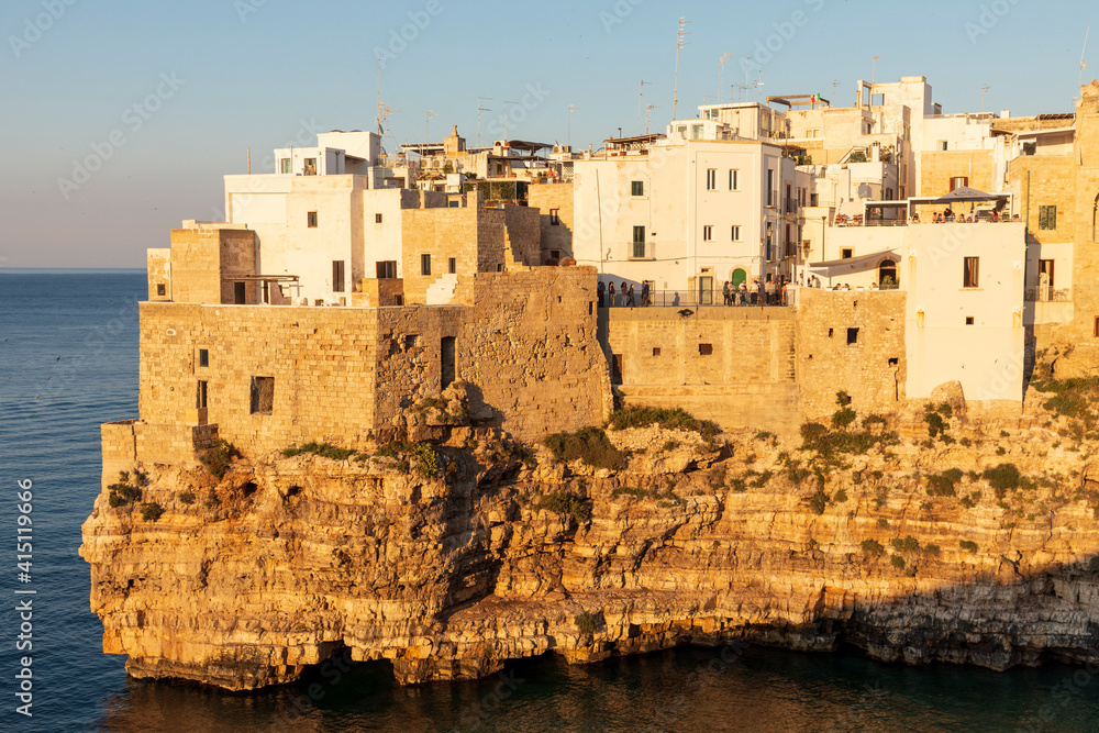 Italy, Apulia, Metropolitan City of Bari, Polignano a Mare. View of part of the old town, built on cliffs over the Adriatic Sea.