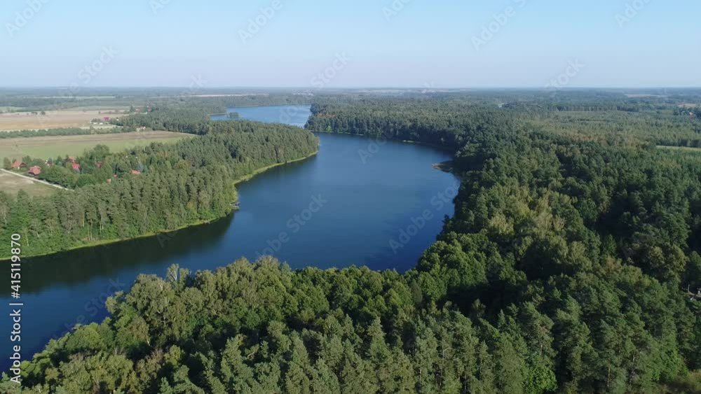 A large forest surrounding the blue lake. Aerial video. A large forest surrounding the blue lake. Aerial video.