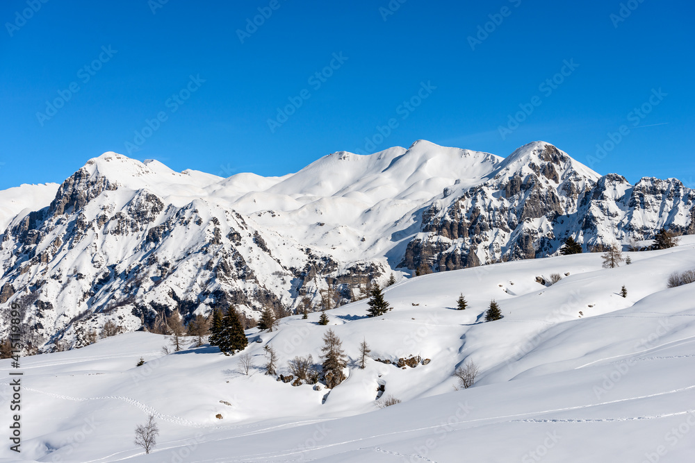 Mountain range of the Monte Carega in winter with snow, also called the small Dolomites view from the Altopiano della Lessinia (Lessinia Plateau). Veneto and Trentino Alto Adige, Italy, Europe.