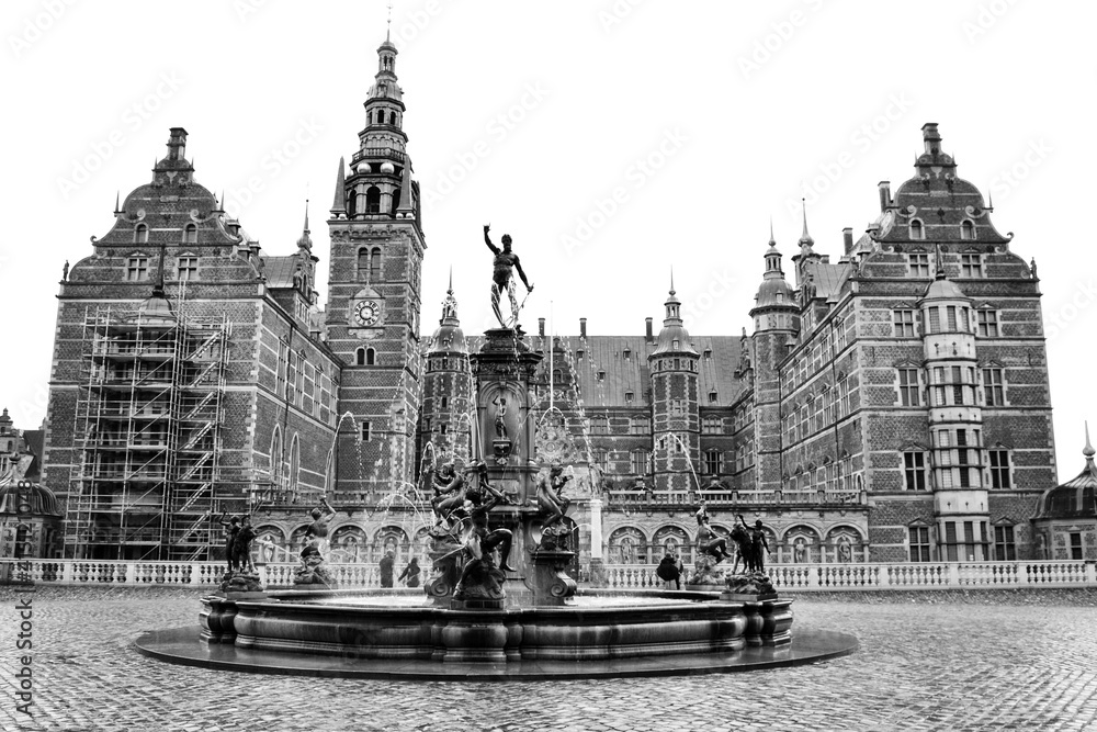 Beautiful fountain on the background of the Castle Complex in Hillerod, Denmark. Black and white photo